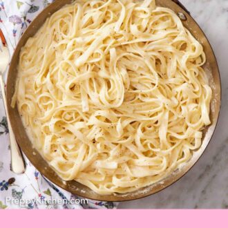 Pinterest graphic of an overhead view of a skillet of fettucine alfredo.