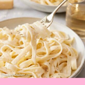 Pinterest graphic of a fork lifting up a bite of fettucine alfredo from a plate.