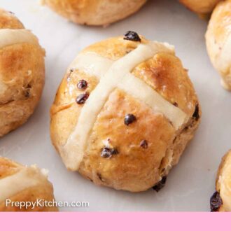 Pinterest graphic of hot cross buns on a marble surface.