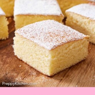 Pinterest graphic of multiple pieces of sliced hot milk cake topped with powdered sugar on a wooden serving board.