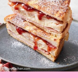 Pinterest graphic of a plate with two halves of a Monte Cristo sandwich stacked on top of each other and dusted in powdered sugar.