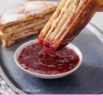 Pinterest graphic of half of a Monte Cristo sandwich dipped into a bowl of jam.