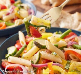 Pinterest graphic of a fork lifting up a bite of pasta primavera from a bowl with a second bowl and torn bread in the back.