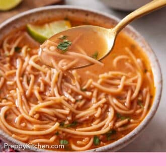 Pinterest graphic of a bowl of sopa de fideo with a spoonful out up.