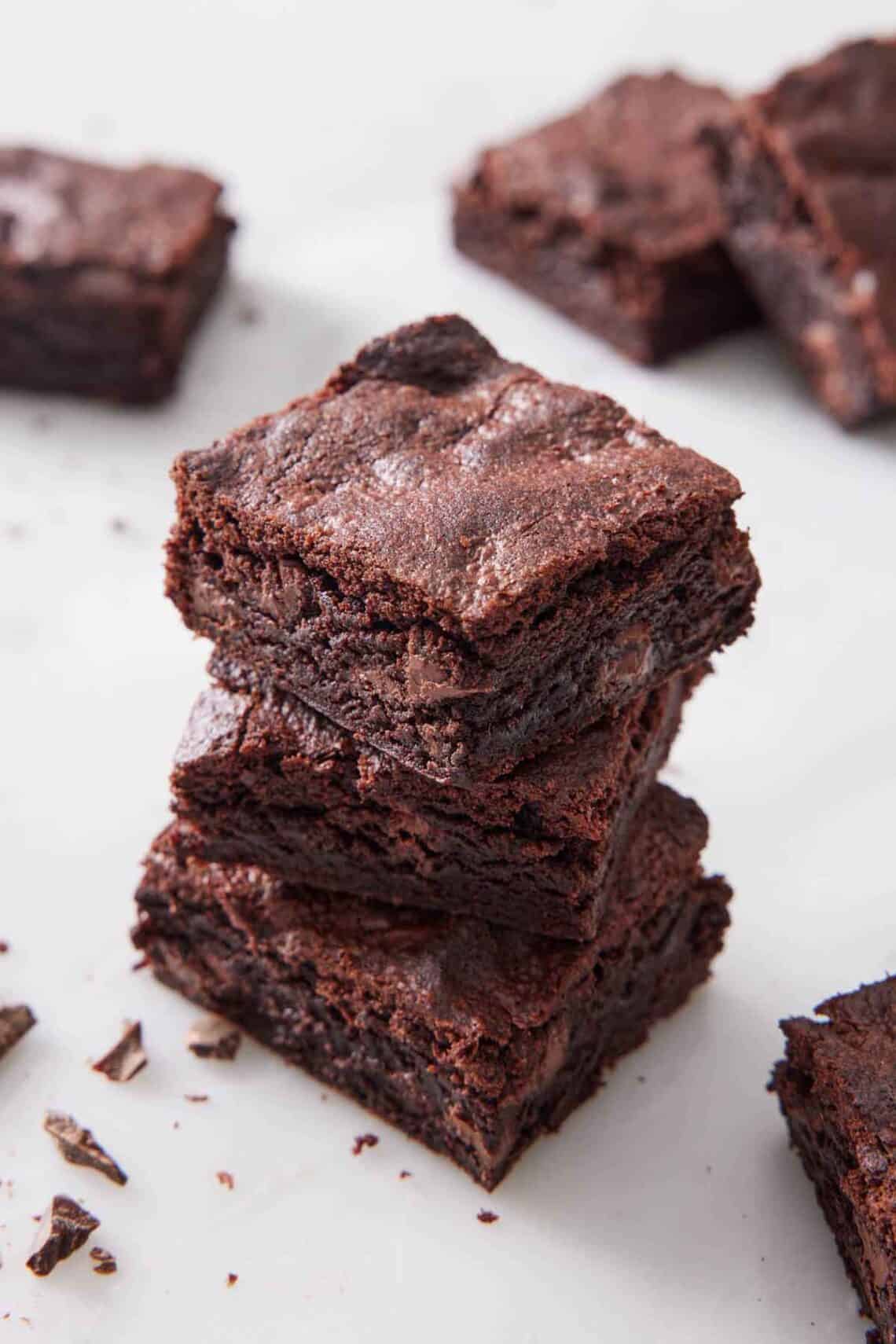 A stack of three air fryer brownies. More brownies in the background.