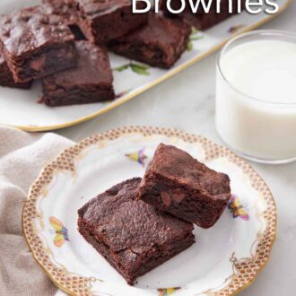 Pinterest graphic of a plate with two pieces of air fryer brownies with a glass on milk in the back along with a platter more.