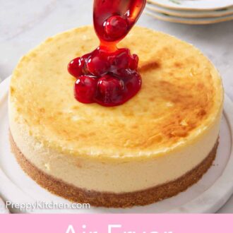 Pinterest graphic of cherry sauce spooned over an air fryer cheesecake.