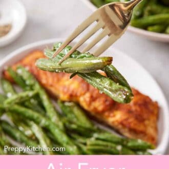 Pinterest graphic of a fork lifting up a three pieces of air fryer green beans from a plate with green beans and salmon.
