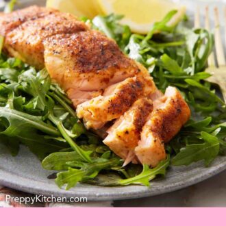 Pinterest graphic of a plate of greens with air fryer salmon on top, flaked.
