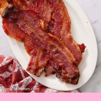 Pinterest graphic of a platter with candied bacon with a linen napkin on the side.