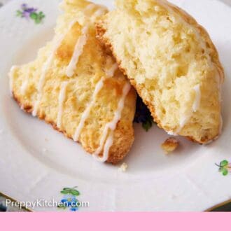 Pinterest graphic of a plate with a lemon scone torn in half. A drizzle of icing over the torn scone.