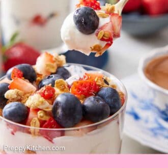Pinterest graphic of a spoonful of yogurt parfait lifted from the glass.