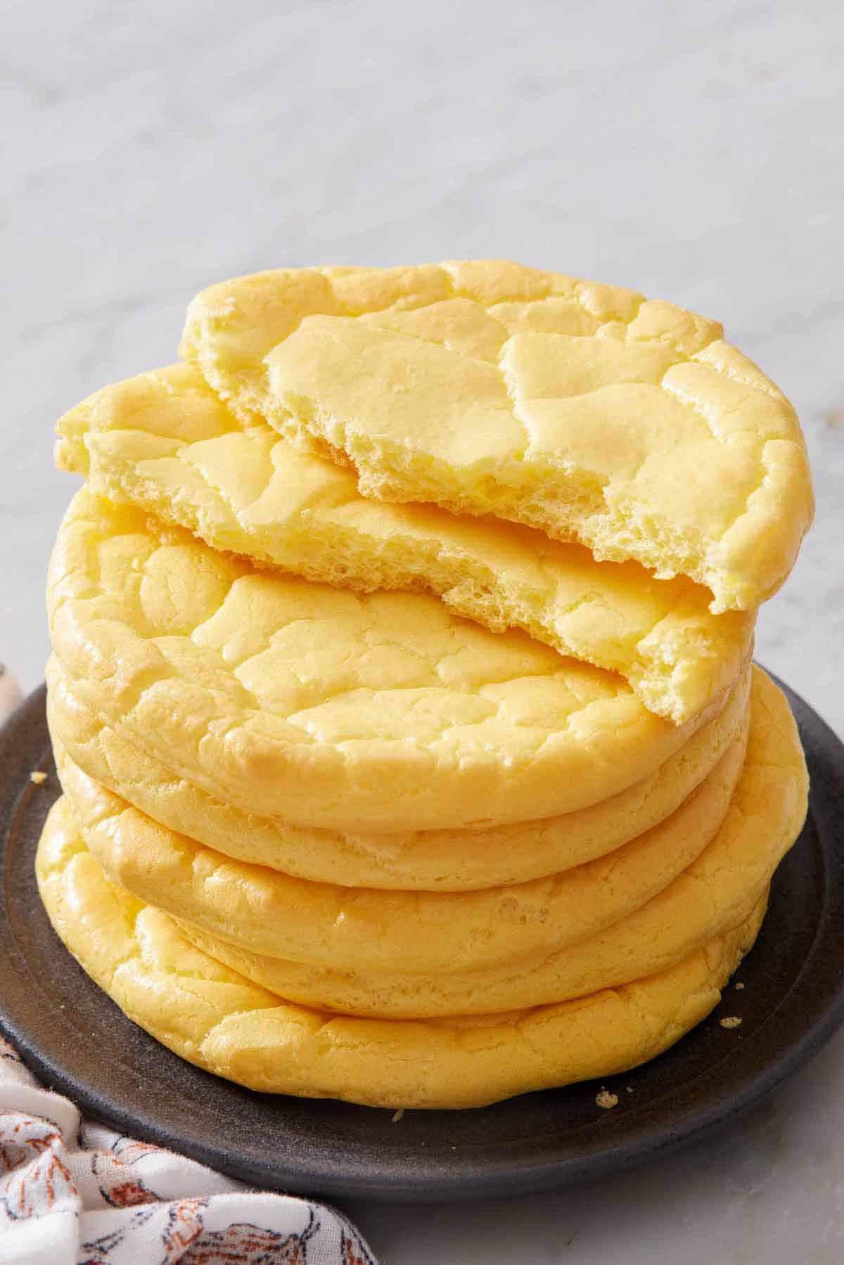 A stack of cloud bread with the top one torn in half.