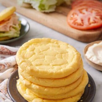 Pinterest graphic of a plate with a stack of five cloud bread with sandwich fillings in the background.