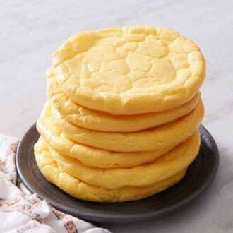 A plate with a stack of six cloud bread. A napkin on the side.