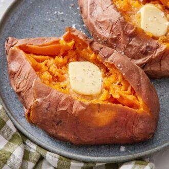 A plate with two instant pot sweet potatoes with slightly melted butter on top.