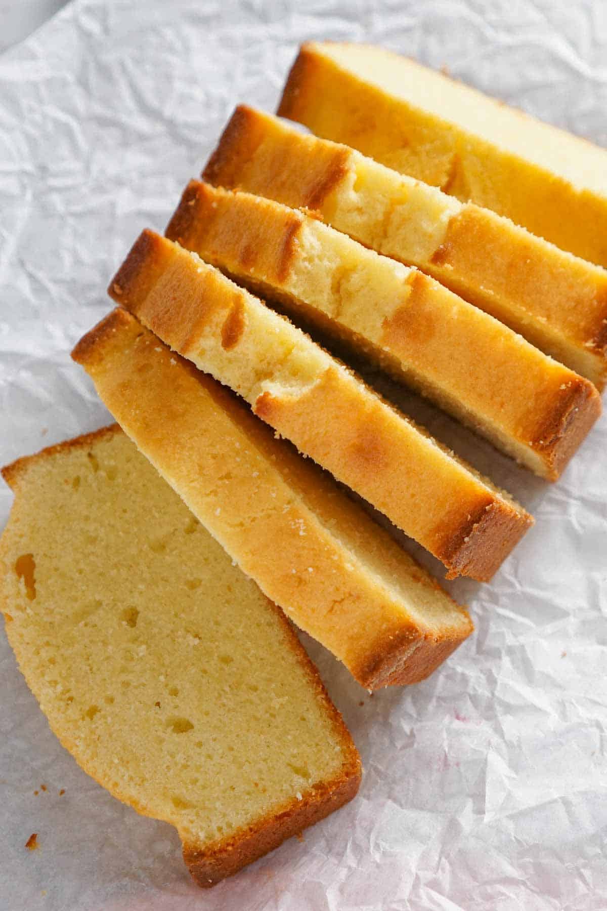 Overhead view of a loaf of pound cake sliced.