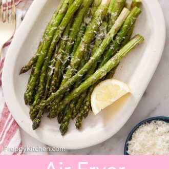 Pinterest graphic of a platter of air fryer asparagus with a lemon wedge.