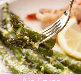 Pinterest graphic of a fork holding up a bite of air fryer asparagus from a plate.