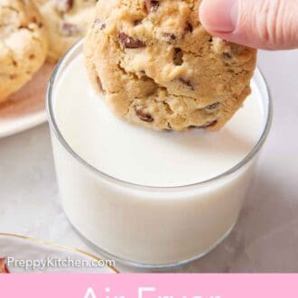 Pinterest graphic of an air fryer cookie dunked into a glass of milk. More cookies in the background.