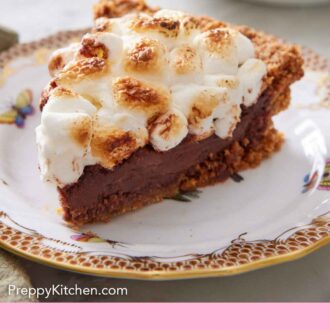 Pinterest graphic of a plate with a slice of s'more pie with another in the background.