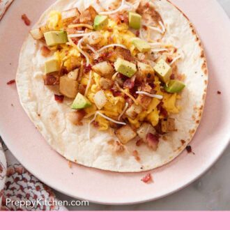Pinterest graphic of a plate with an open faced breakfast taco.
