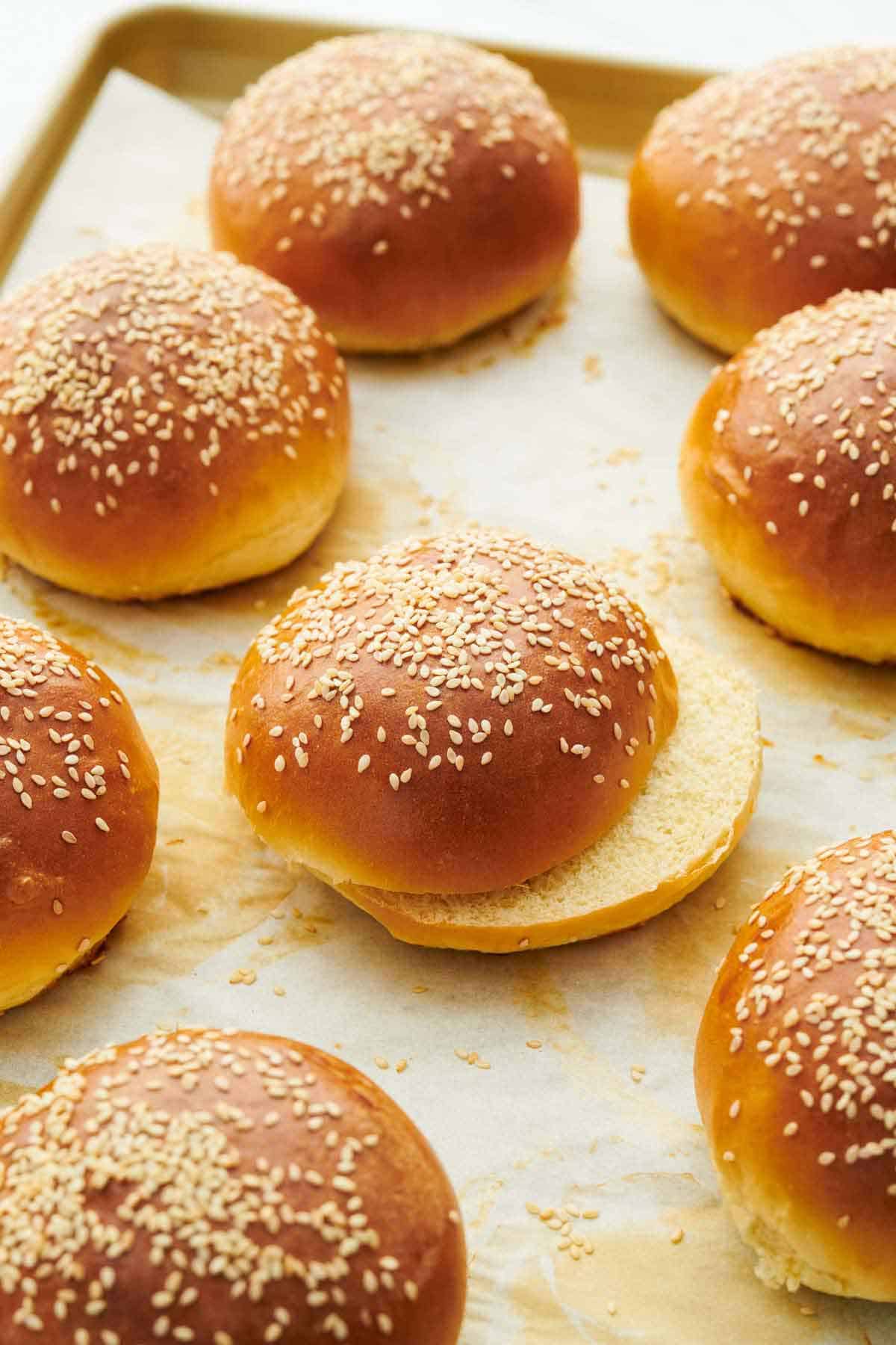 A sheet pan with multiple homemade burger buns.