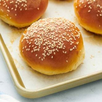 Close up of a burger bun on a sheet pan.