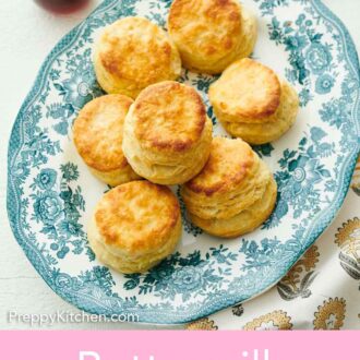 Pinterest graphic of overhead view of a platter with buttermilk biscuits with honey, butter, and another plate of biscuits.