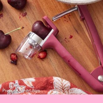 Pinterest graphic of cherries being pitted with a cherry pitter.