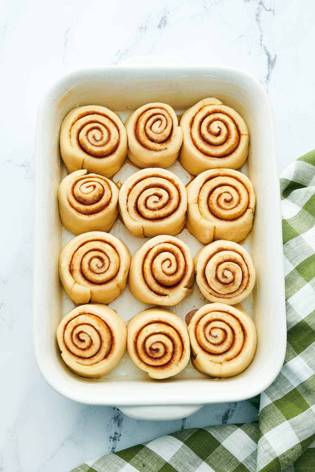 Overhead view of cinnamon rolls in a baking dish before baking.
