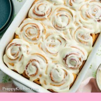 Pinterest graphic of an overhead view of cinnamon rolls with a layer of icing.