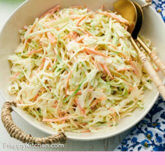 Pinterest graphic of a serving plate of coleslaw with serving spoons tucked in.