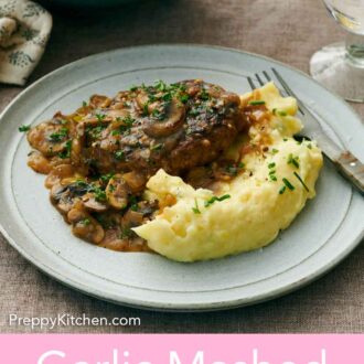 Pinterest graphic of a plate with garlic mashed potatoes with some meat with mushrooms and gravy.