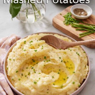 Pinterest graphic of a bowl of Instant Pot mashed potatoes topped with chives and melted butter. A wooden spoon scooped in.