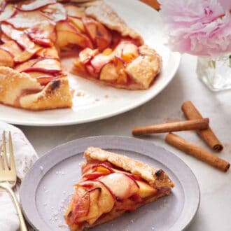 Pinterest graphic of a plate of peach galette on a plate with the rest of the galette in the background.