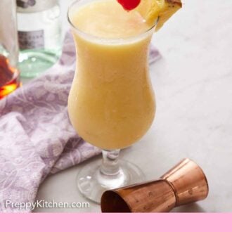 Pinterest graphic of a glass of piña colada, each with a straw and pineapple slice, with a hand placing a maraschino cherry on top.