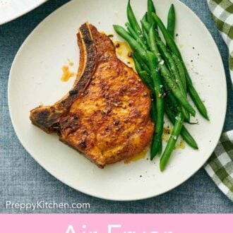 Pinterest graphic of an air fryer pork chop and green beans on a plate.