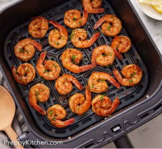 Pinterest graphic of an air fryer basket of air fryer shrimp.