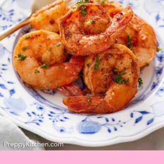 Pinterest graphic of a plate with a serving of air fryer shrimp with parsley garnish.