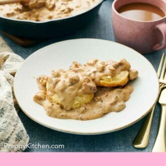 Pinterest graphic of a white plate of biscuits and gravy. A skillet of more gravy in the background along with a pink mug.