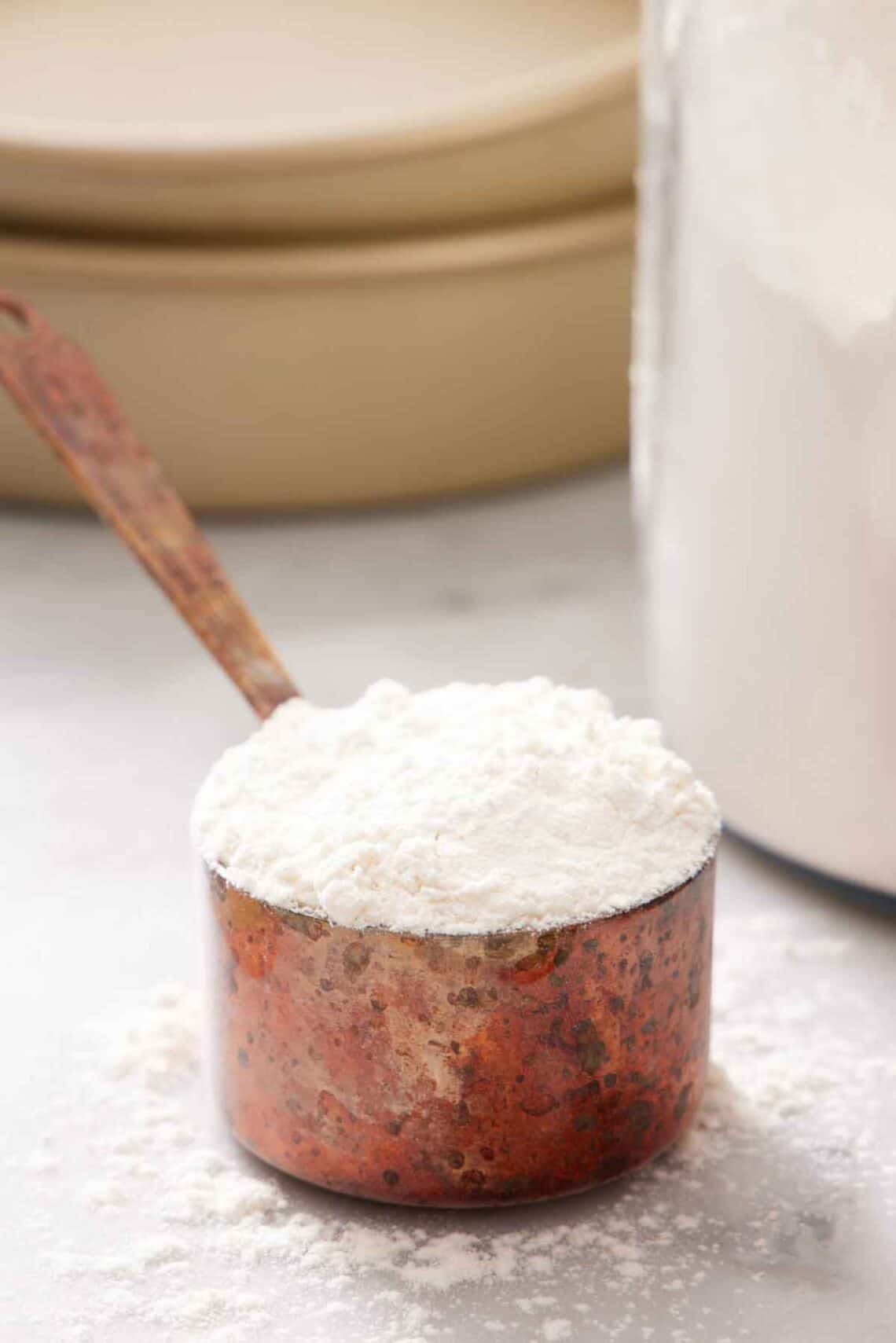 A measuring cup with cake flour substitute.