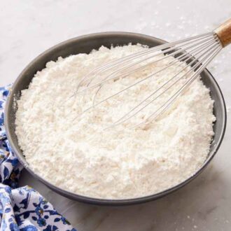 Cake flour substitute in bowl with a whisk.