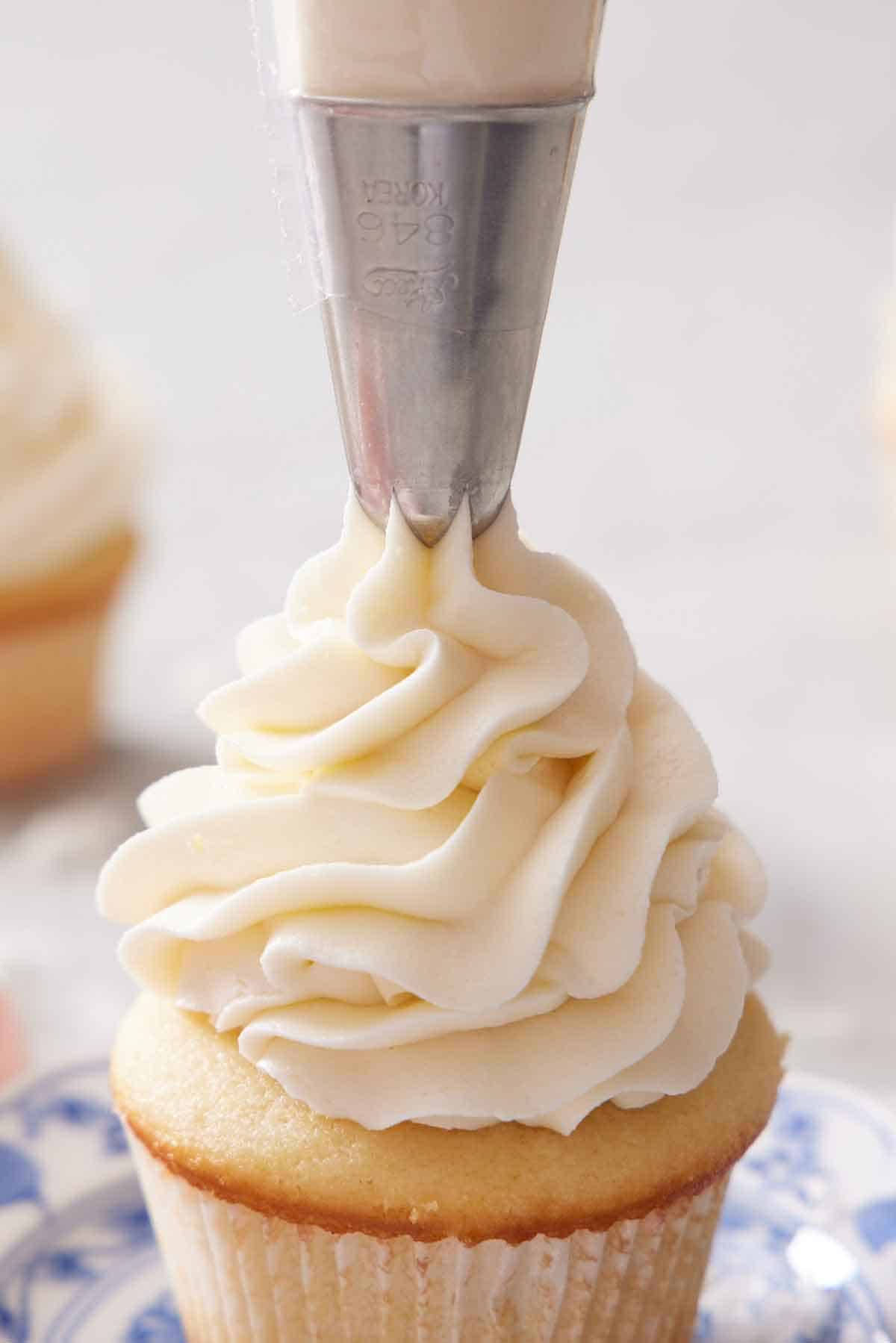 Coconut frosting piped onto a cupcake.