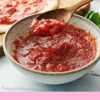 Pinterest graphic of a spoon lifting up homemade pizza sauce from a bowl.