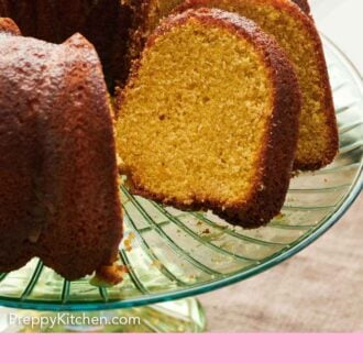 Pinterest graphic of a close up of sliced rum cake on a cake stand, showing the interior.