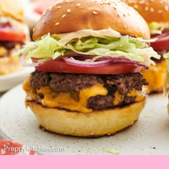 Pinterest graphic of a side view of a smash burger topped with tomato, onion, and lettuce.