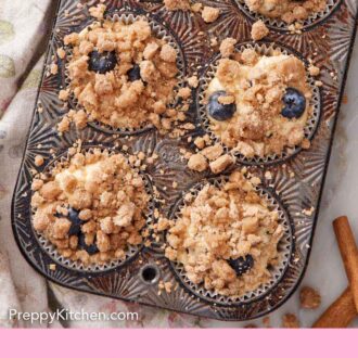 Pinterest graphic of blueberry muffins topped with streusel in a muffin tin.