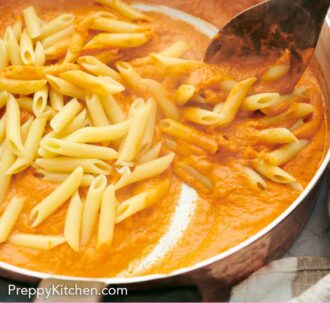 Pinterest graphic of pasta stirred in vodka sauce with a wooden spoon.