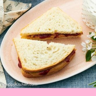 Pinterest graphic of a platter with a peanut butter and jam sandwich made with white bread, cut into two triangles.